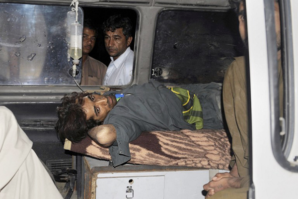 An injured Pakistani being ambulanced in Dalbandin, April 17. Banaras Khan—AFP