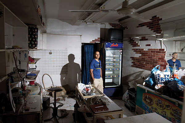 Hussain at his empty store in Athens, June 14, 2012. Nikos Pilos.