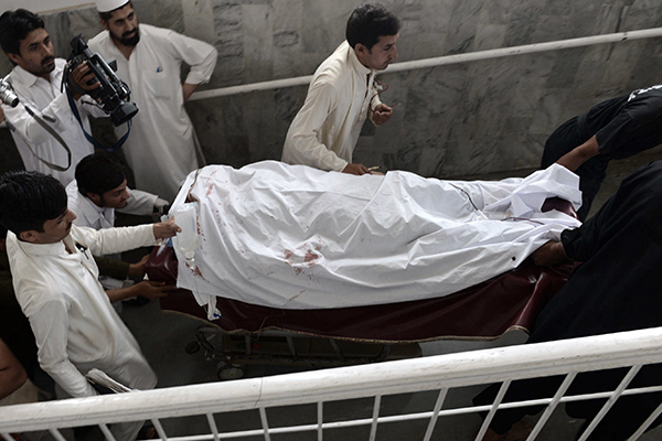 A female health worker being moved after an attack in Peshawar on May 28. A. Majeed—AFP