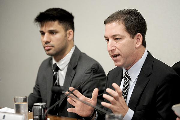 Greenwald (right) with his partner, David Miranda. Evaristo Sa—AFP
