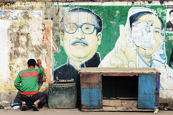 A man relieves himself in Dhaka, Jan. 3. Roberto Schmidt—AFP