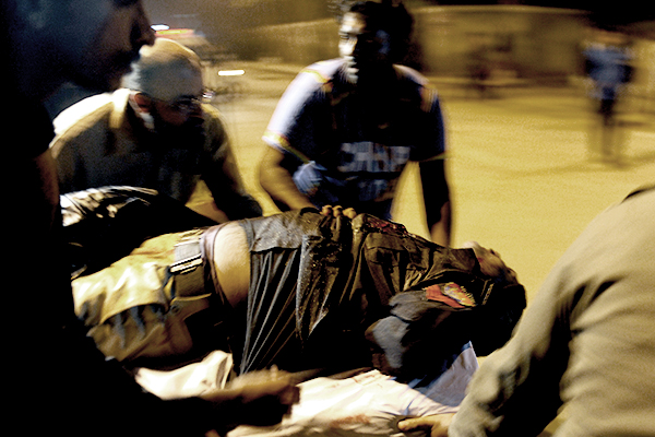 An injured policeman being moved to hospital, Jan. 25. Rizwan Tabassum—AFP