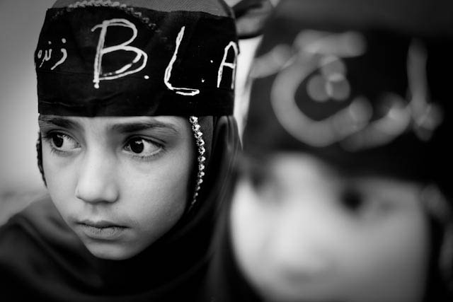 Two Baloch girls wear Baloch Liberation Army bandanas during a demonstration in Quetta. Photograph by Marc Wattrelot