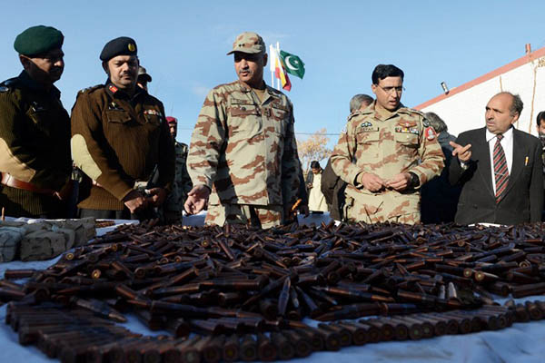FC officials display seized arms and ammunition during a media briefing, January 2014. Banaras Khan—AFP