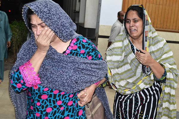 Rashid Rehman’s relatives at hospital after his killing. SS Mirza—AFP