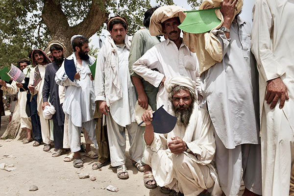 Internally displaced tribesmen queue up for food in Bannu. A. Majeed—AFP