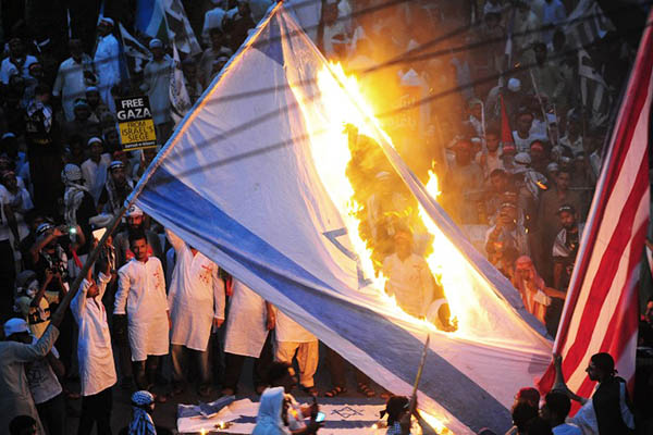 Jamaat-e-Islami activist burn Israeli flags during a pro-Palestine demonstration in Karachi, August 2014. Rizwan Tabassum—AFP