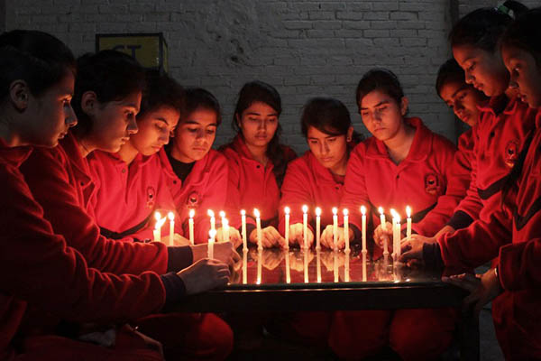 Indian schoolchildren hold a candle-lit vigil for the victims of the Peshawar siege. Shammi Mehra—AFP