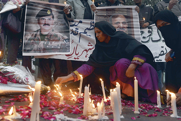 A vigil for Peshawar in Lahore, Dec. 17. Arif Ali—AFP