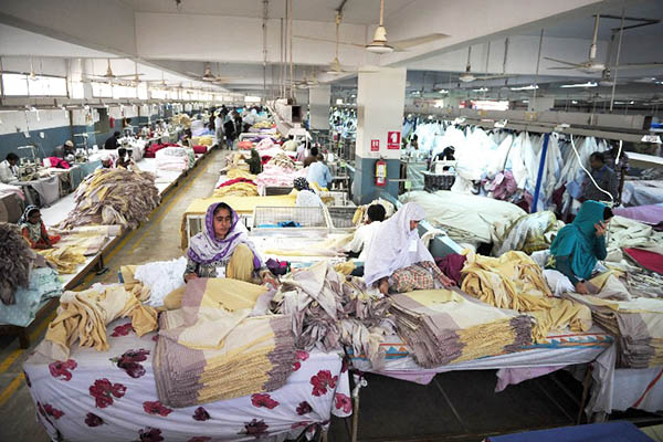 Employees at a clothing factory in Karachi on Nov. 11, 2014. Asif Hassan—AFP