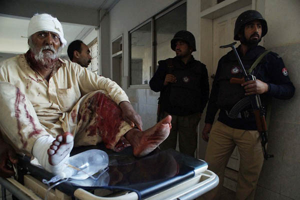 A man receives treatment after being injured in Peshawar. A. Majeed—AFP