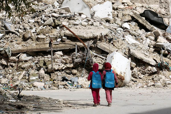 Syrian girls walk to school. Zein al-Rifai-AMC—AFP