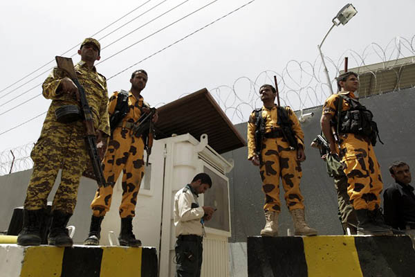 Yemeni security forces stand guard outside the U.N. office in Sanaa. Mohammed Huwais—AFP
