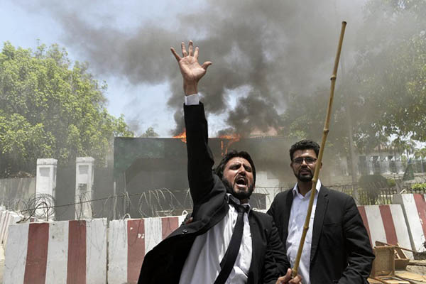 Lawyers set fire to the checkpoint entrance of the Punjab Assembly in Lahore, May 26, 2015. Arif Ali—AFP
