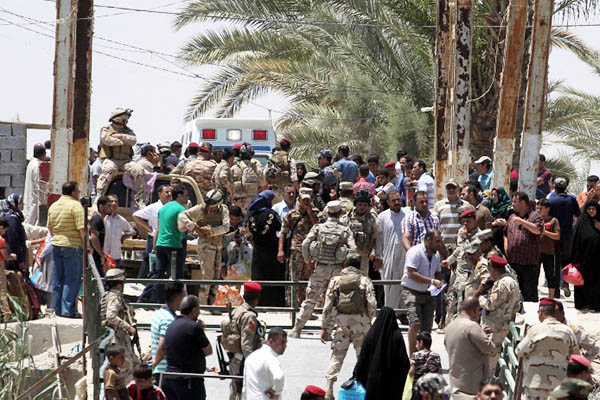 Iraqi soldiers stand guard as residents of Ramadi Anbar province. Sabah Arar—AFP
