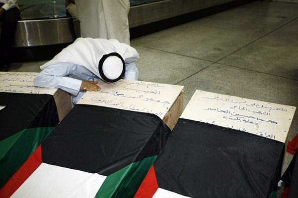 A Kuwaiti man mourns a relative killed in the Friday bombing, Najaf, June 27. Haidar Hamdani—AFP