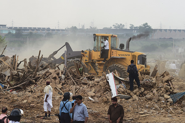 Legal action in Islamabad’s I-11, July 30. Farooq Naeem—AFP