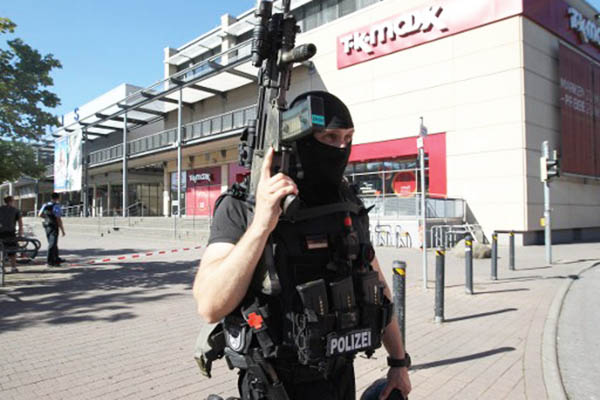 A policeman stands in front of the cinema targeted by a masked gunman. Daniel Roland—AFP