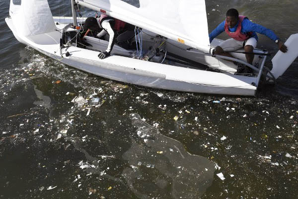 Sailors train in waste-littered waters at Rio de Janeiro’s Guanabara Bay. William West—AFP