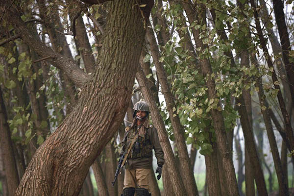 An Indian paramilitary trooper stands guard in Srinagar. Tauseef Mustafa—AFP